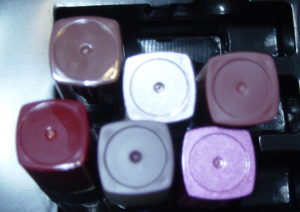 bottom ends of six lipstick tubes with no color names