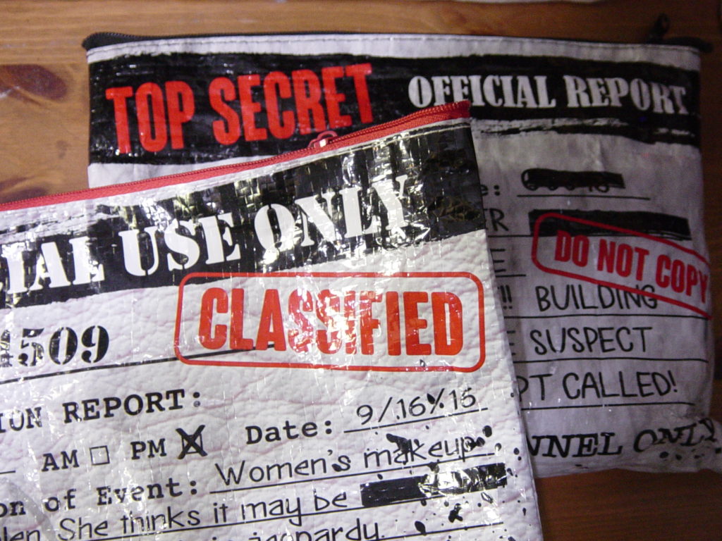 novelty makeup bags with "classified" and "top secret" markings